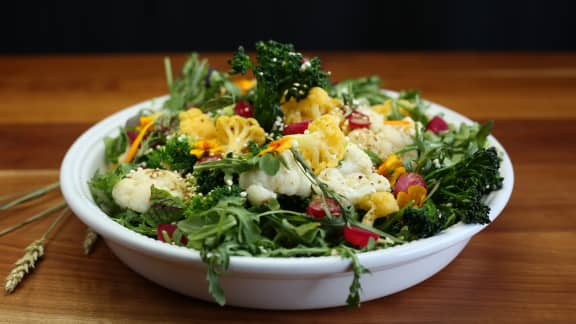 Salade de légumes fleurs, vinaigrette émulsionnée à la moutarde et à l'estragon, oignons marinés et quinoa soufflé