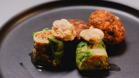 Boulettes frites de ricotta et palourdes, rouleaux de sucrine à la saucisse