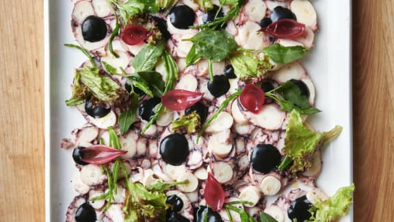 Carpaccio de pieuvre, oignons marinés, mayo à l’encre de seiche et petites verdures des mers