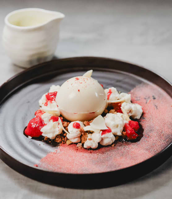 Sphère de chocolat au riz au lait, compotée de fraises et rhubarbe, crumble de pistaches